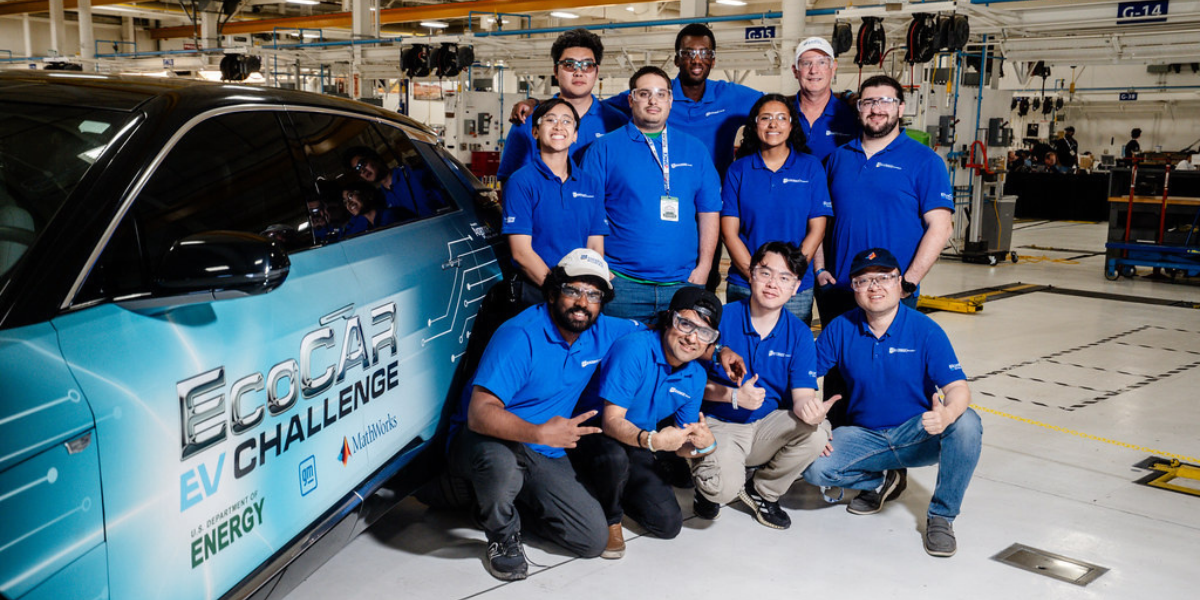 Students from a BCOE engineering team gathered around a race car project