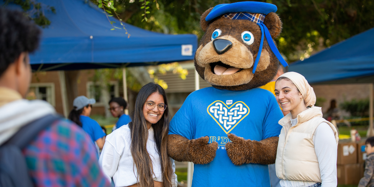 UCR graduate celebrating near the Bell Tower