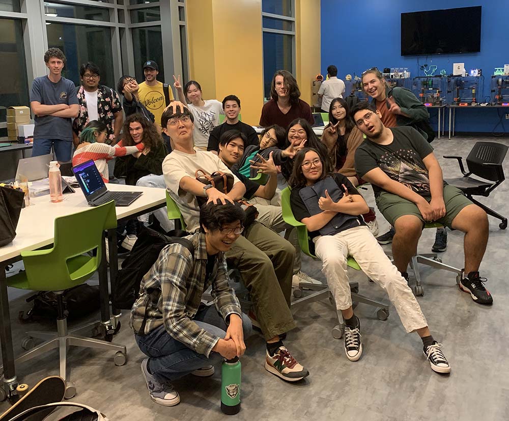 men and women casually dressed and sitting striking comical poses  