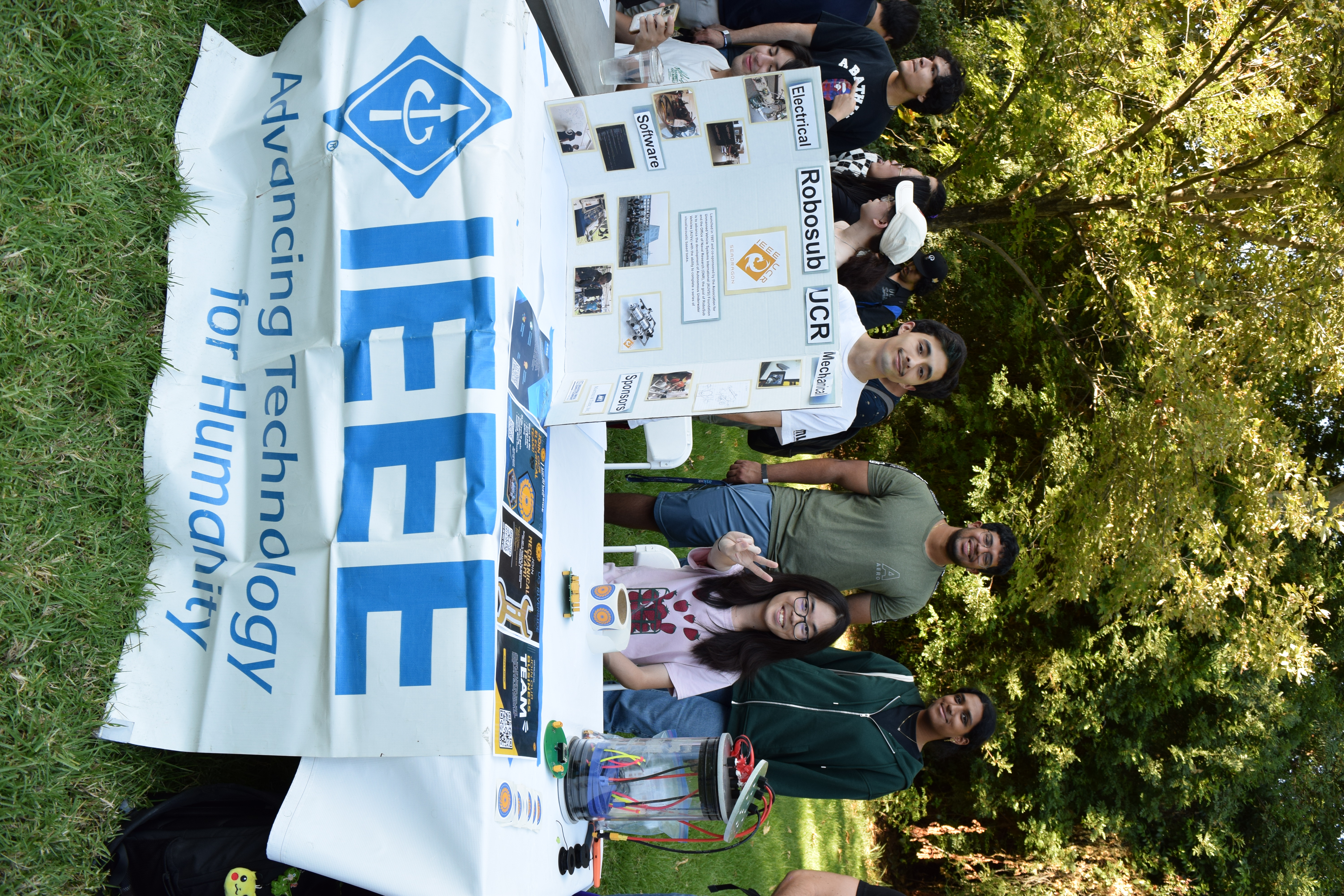 Members of Institute of Electrical and Electronics Engineers at a table presenting and tabling