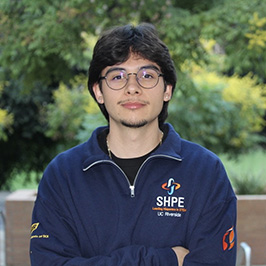 Engineering major Juan Ascencio Martinez wearing a navy blue Society of Hispanic Professional Engineers jacket.