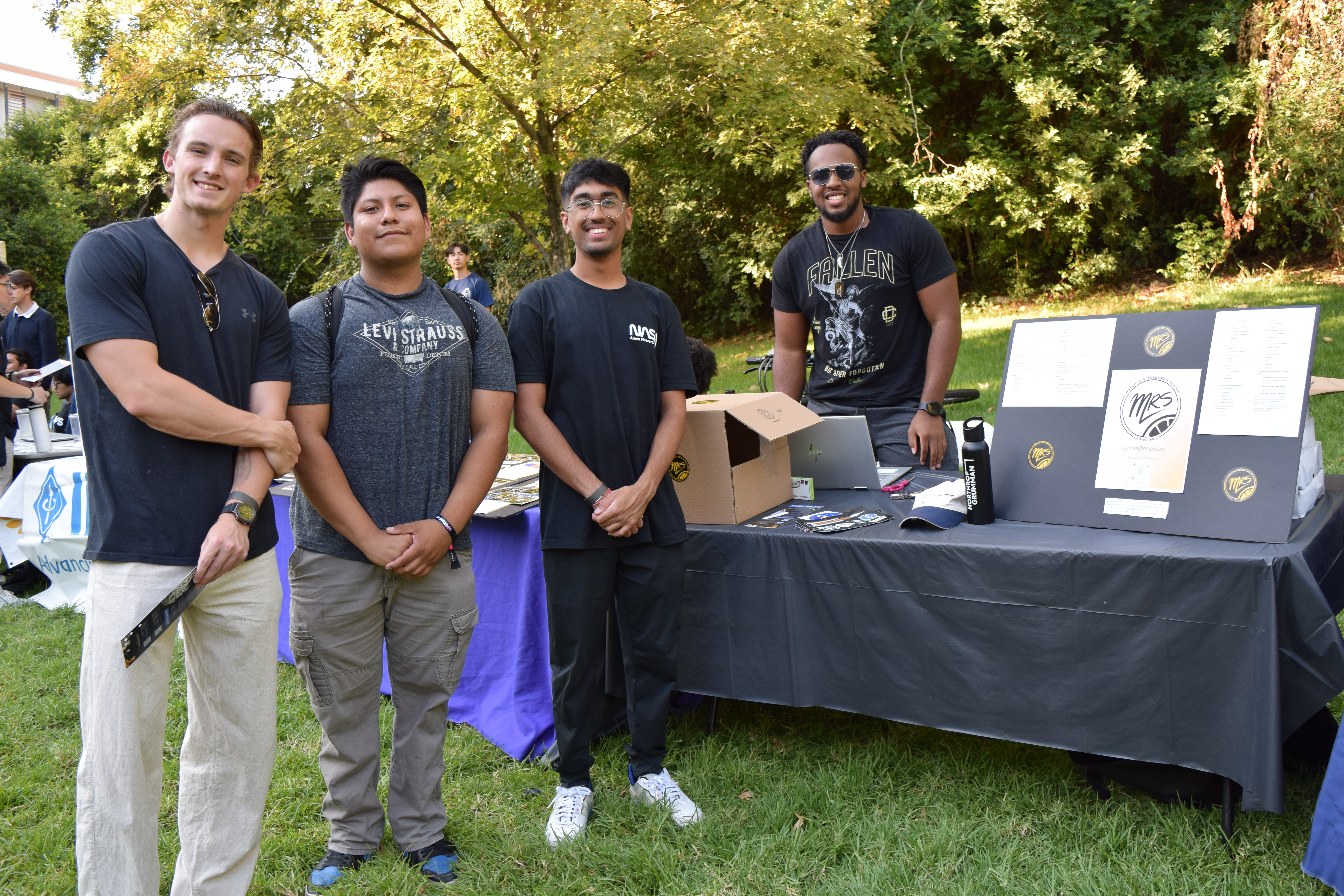 Members of Material Research Society standing by their table 