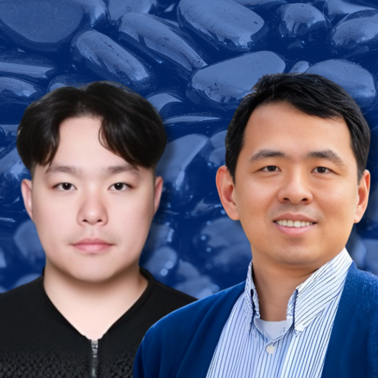 Portrait of two researchers against a blue-toned background of hematite material; one wears a dark top, the other a collared shirt with a blue jacket, both facing forward.