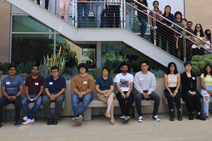 Photo of UCR data science students posing in an open courtyard for a group photo.