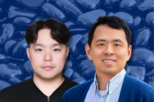 Portrait of two researchers against a blue-toned background of hematite material; one wears a dark top, the other a collared shirt with a blue jacket, both facing forward.