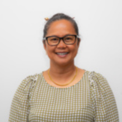 Headshot of Jane Sabitsana-Nakao, a woman with dark hair tied back, wearing glasses and a light green checkered top, smiling.