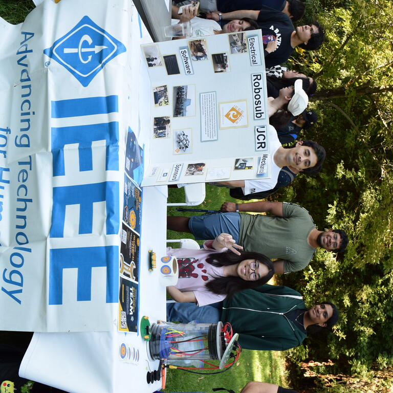 Members of Institute of Electrical and Electronics Engineers at a table presenting and tabling