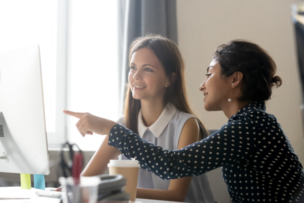 woman pointing at computer screen
