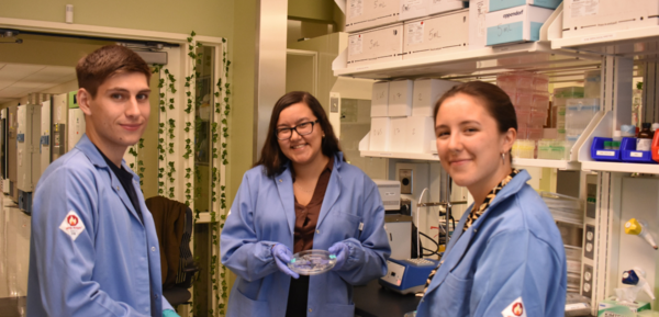 Three student researchers in the lab
