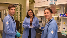 Three student researchers in the lab