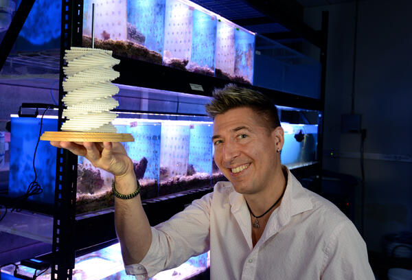 David Kisailus holding example of helicoid technology.