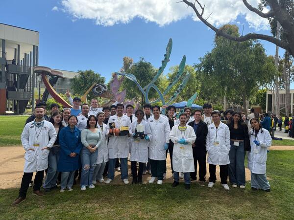 members of AIChE posing together with their project wearing PPE