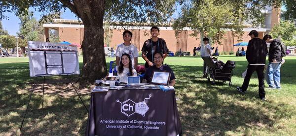 members of AIChE posing outdoors beneath a shade tree
