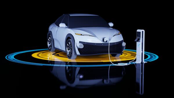 An electric vehicle (EV) is shown charging at a station.