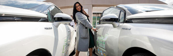 Riverside City Council member Clarissa Cervantes getting into a hydrogen engine car at UCR's Center for Environmental Research and Technology