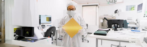 A technician holds a wafer-scale GPU computer chip