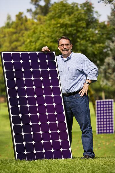 Charlie Gay with a solar panel during his decades-long career in renewable energy.