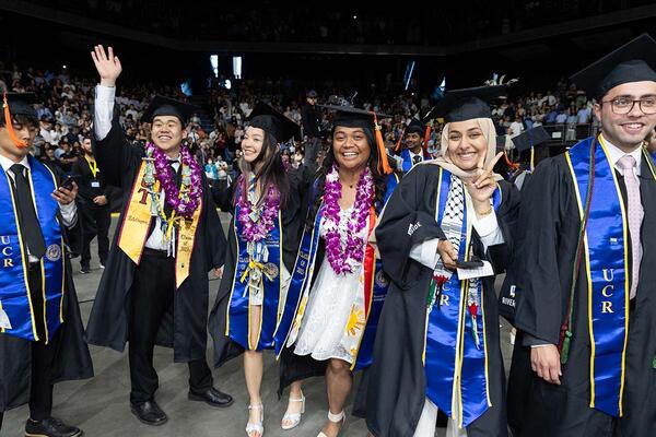 men and women in graduation regalia