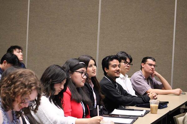 men and women attending a conference breakout session