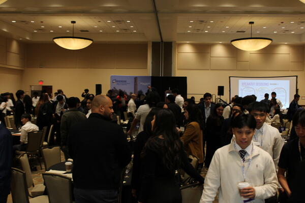 BCOE students and alumni in the main conference room mingling. 