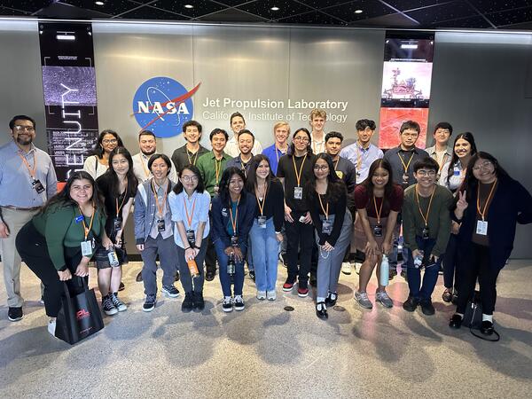 group of BCOE engineering students posing in front of the Nasa JPL building sign   