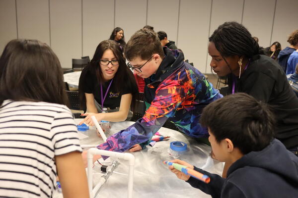 engineering and elementary students working on a project 