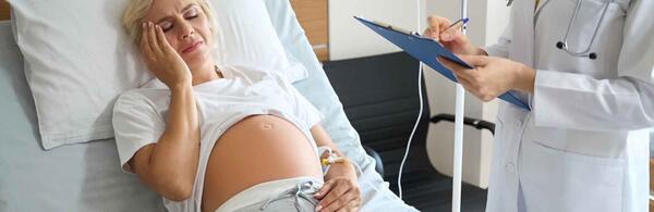 Photo of woman in pain during childbirth at a hospital.