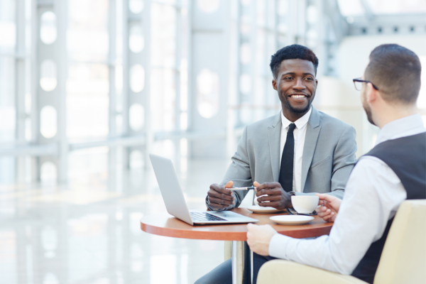 2 men at small conference table