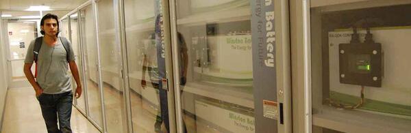 Student walking past row of batteries in Winston Chung Hall 