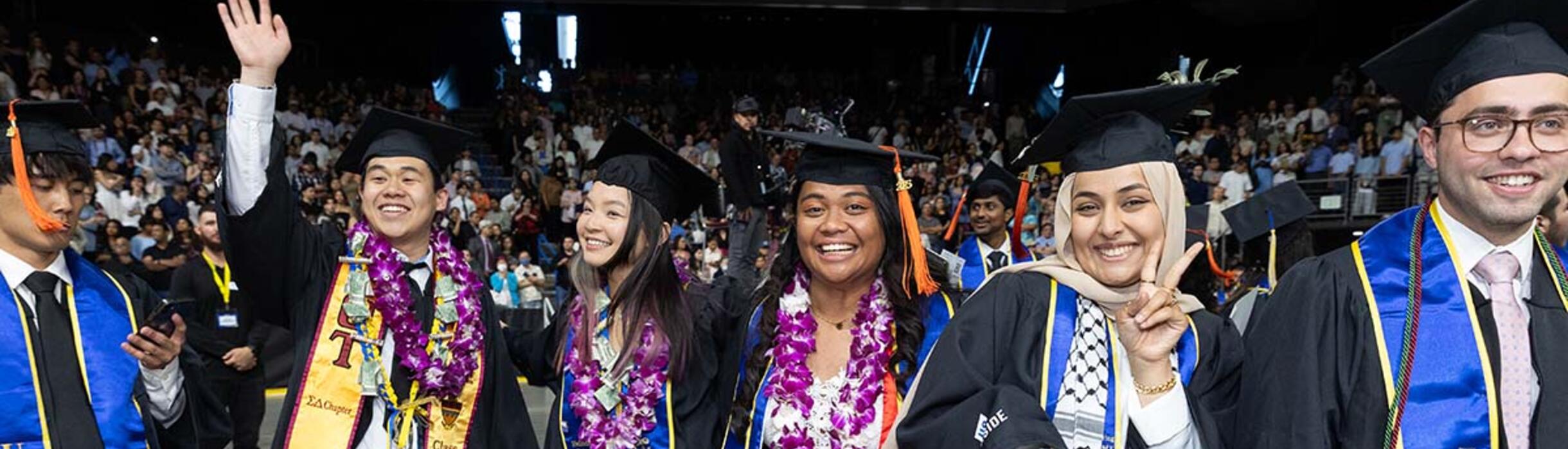 men and women in graduation regalia