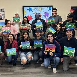 transfer_transition_program.jpg transfer students in the transfer center holding painted canvases